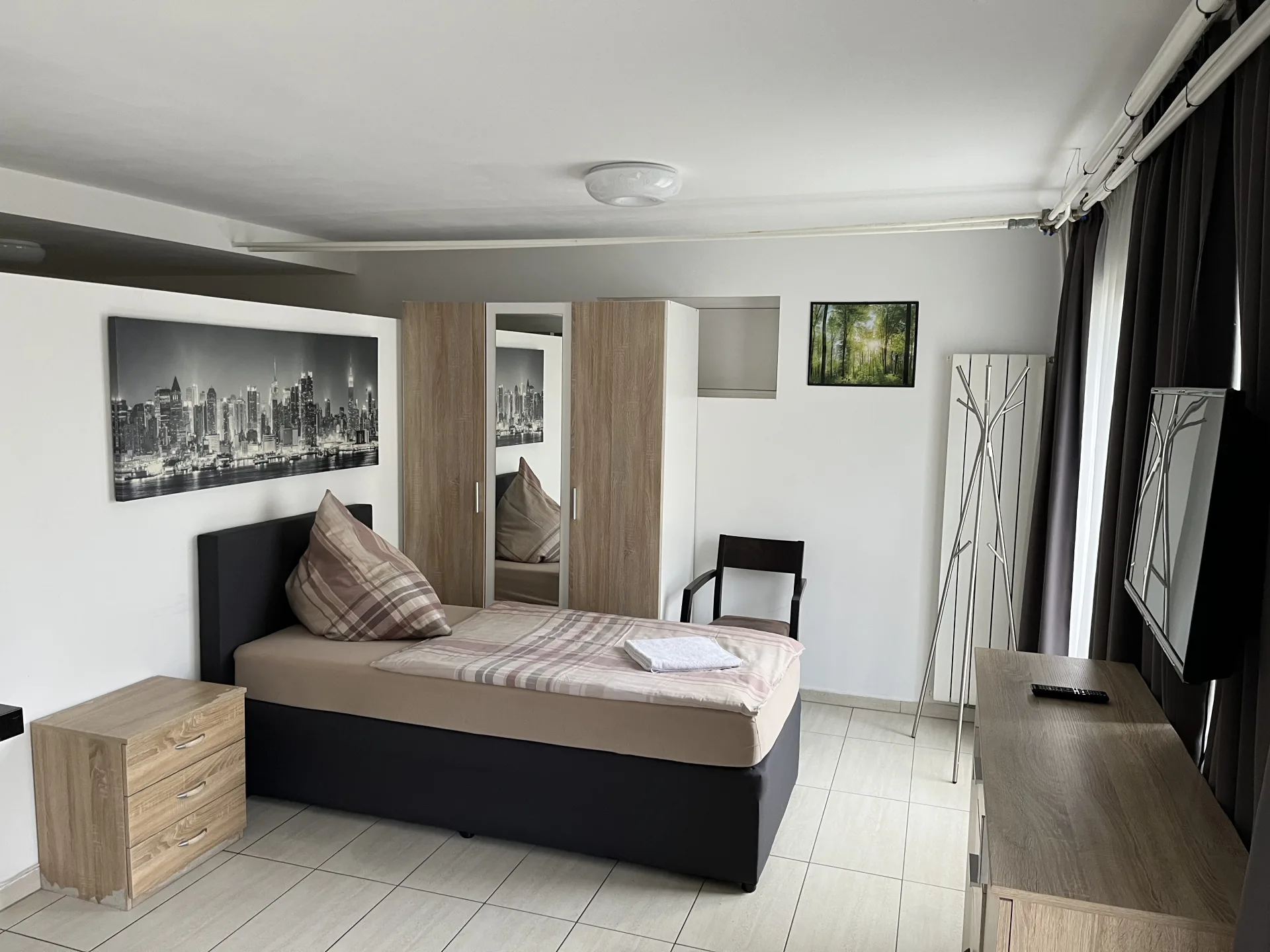 Studio mit Bett, Schrank und Wohnbereich